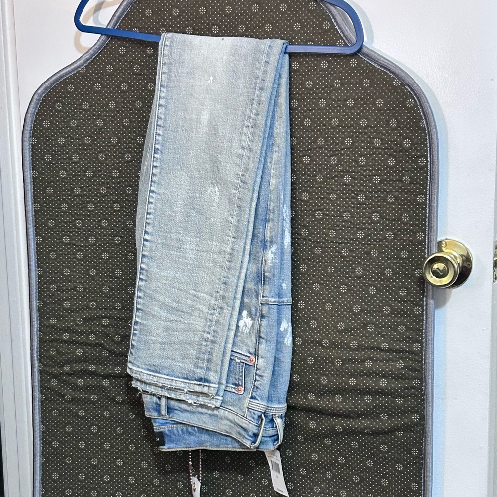 Purple jeans size 32 light blue jeans with a couple paint colors and a knee cut